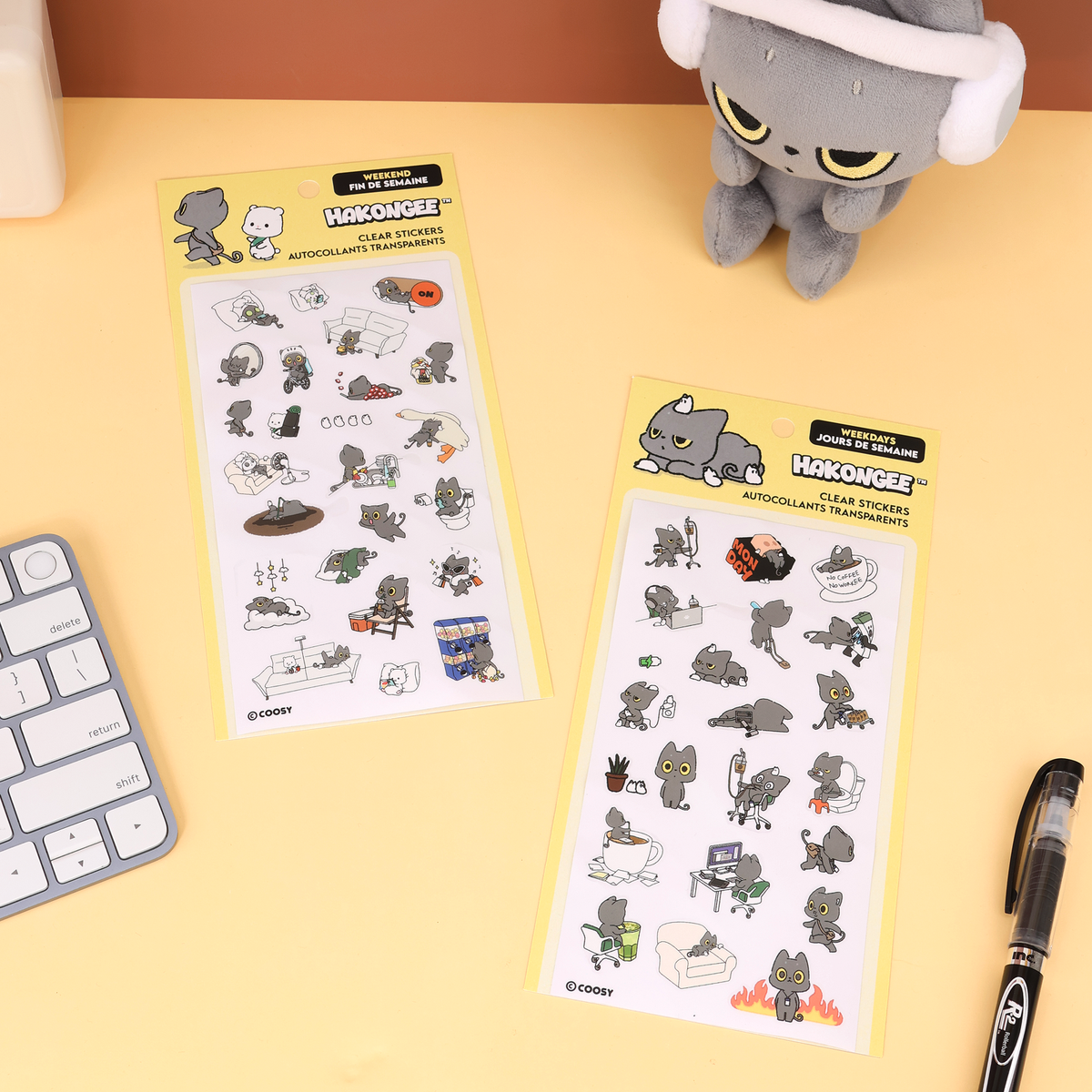 Hakongee Weekday and Weekend clear sticker sheets side by side on a desk with plush and keyboard